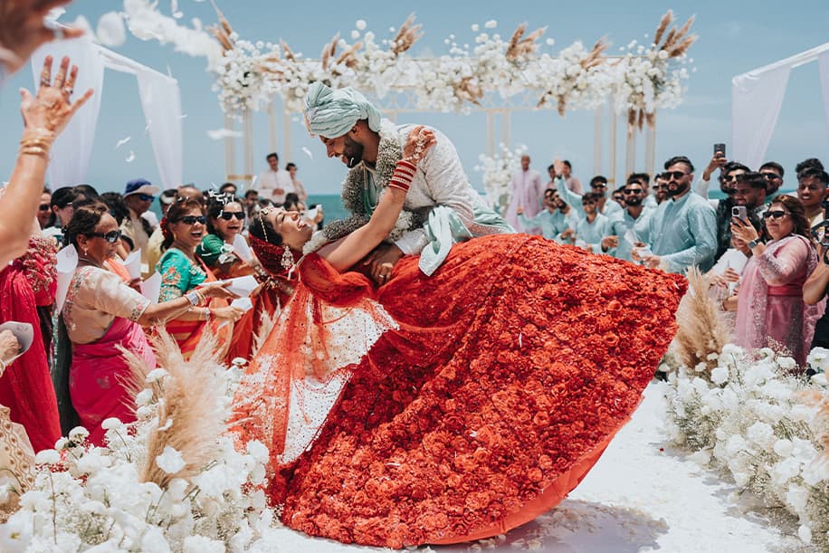 Beach wedding ceremony under a floral arch at Byron Bay